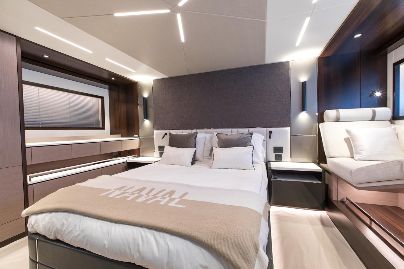 a hotel room with a bed and a couch aboard NAVAL Yacht for Sale