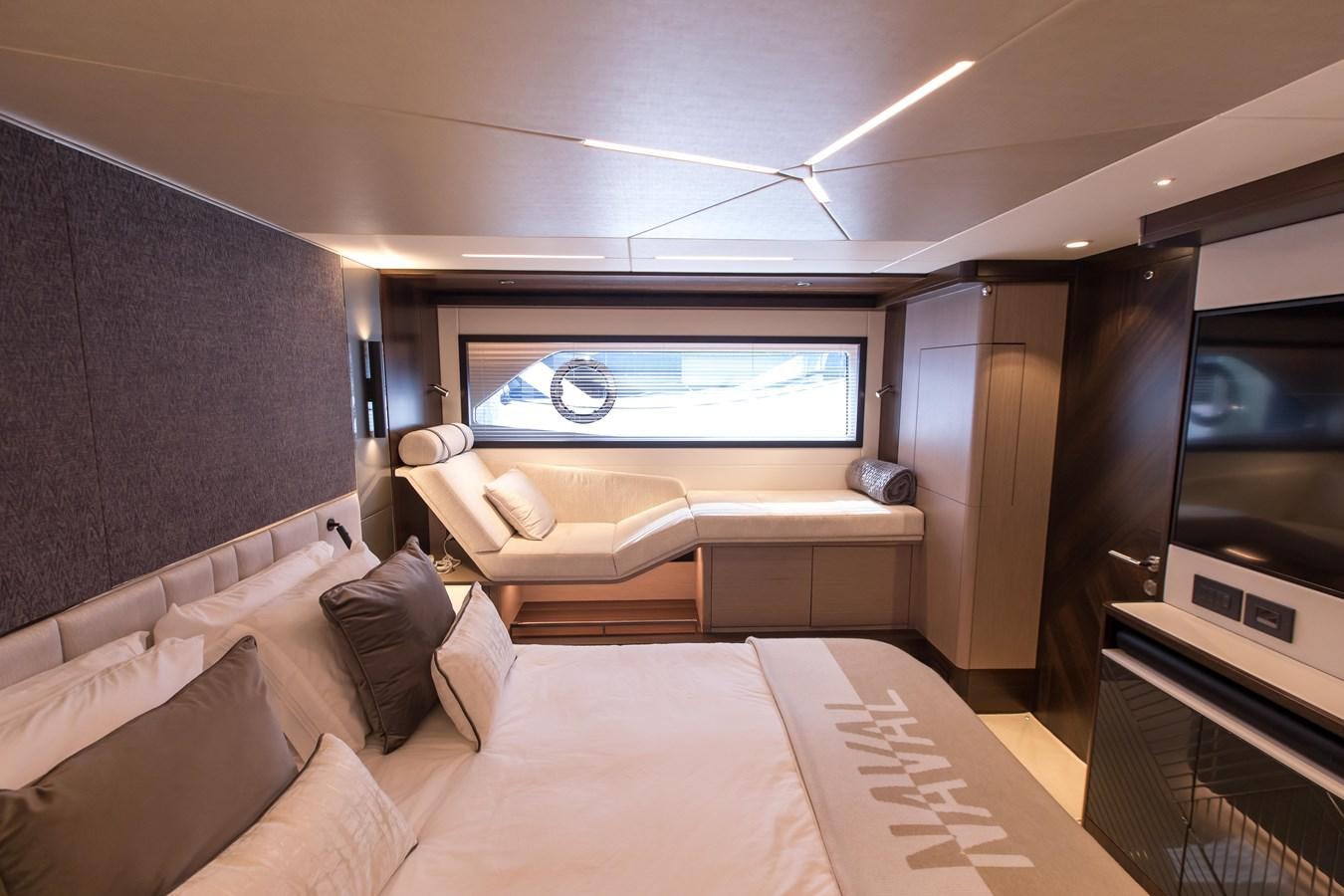 a room with a bed and a tv aboard NAVAL Yacht for Sale