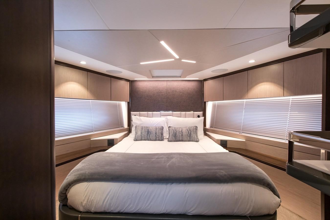 a room with a bed and a window aboard NAVAL Yacht for Sale
