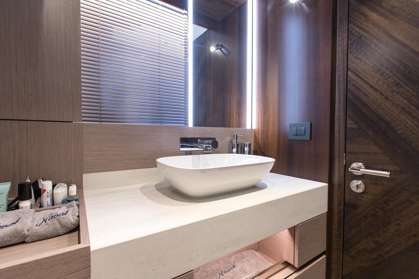 a bathroom with a sink and a mirror aboard NAVAL Yacht for Sale
