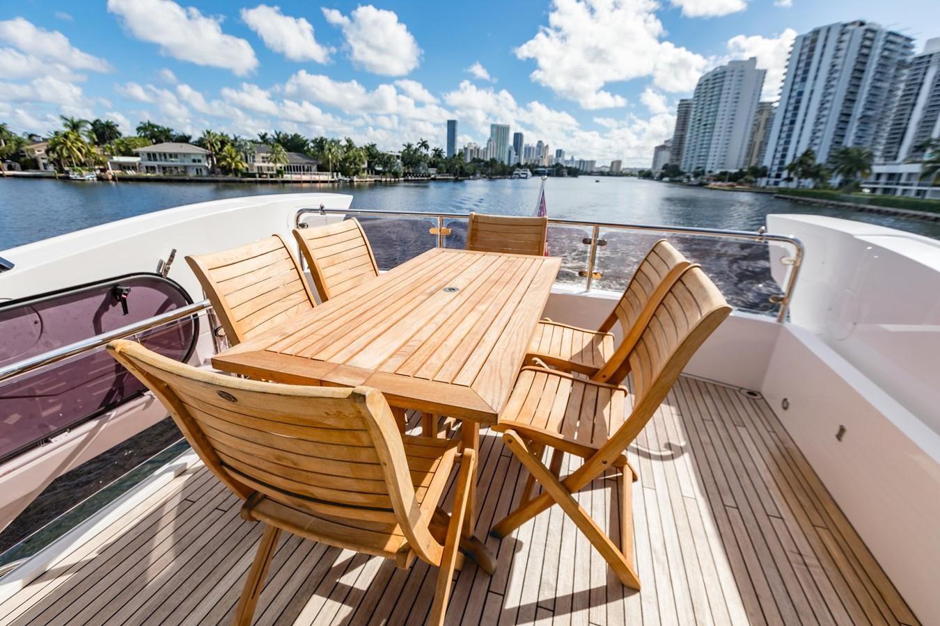 a table and chairs on a boat aboard NAVAL Yacht for Sale
