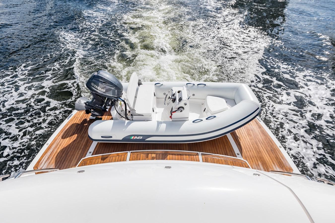a white boat with a helmet on it aboard NAVAL Yacht for Sale