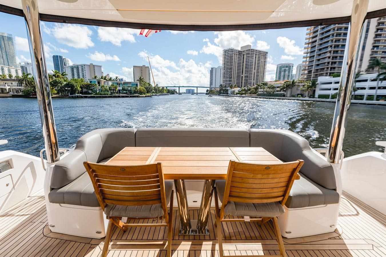a table and chairs on a boat aboard NAVAL Yacht for Sale