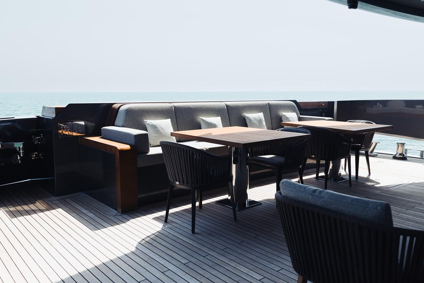 a room with a couch and a table and chairs aboard LUCKY ME Yacht for Sale