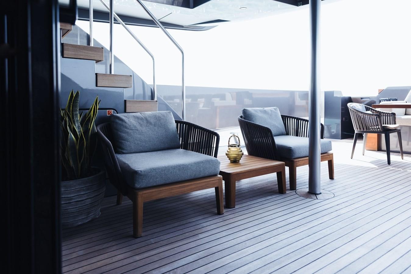 a room with a table and chairs aboard LUCKY ME Yacht for Sale