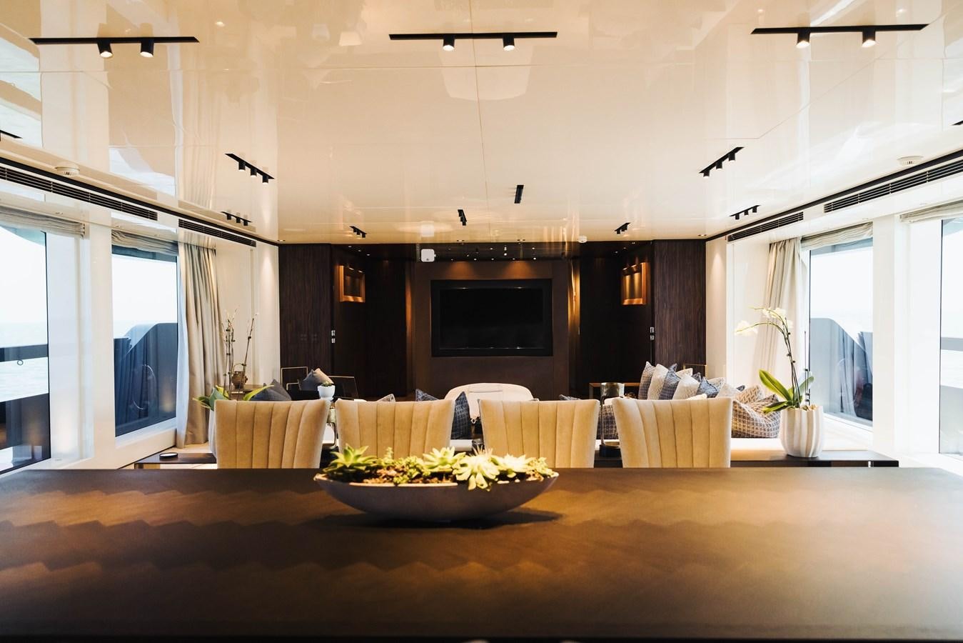 a large living room with a large table and chairs aboard LUCKY ME Yacht for Sale