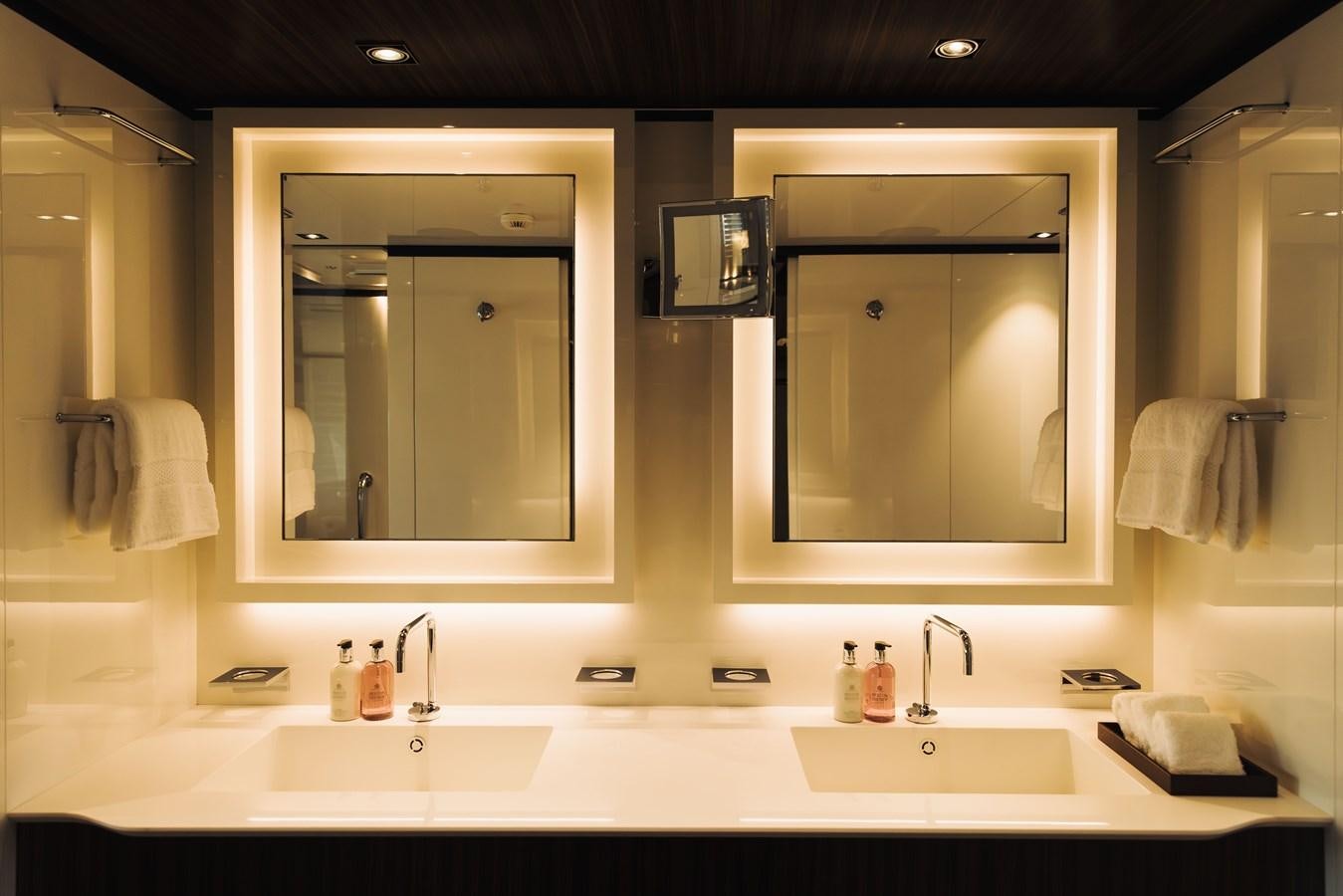 a bathroom with two mirrors aboard LUCKY ME Yacht for Sale