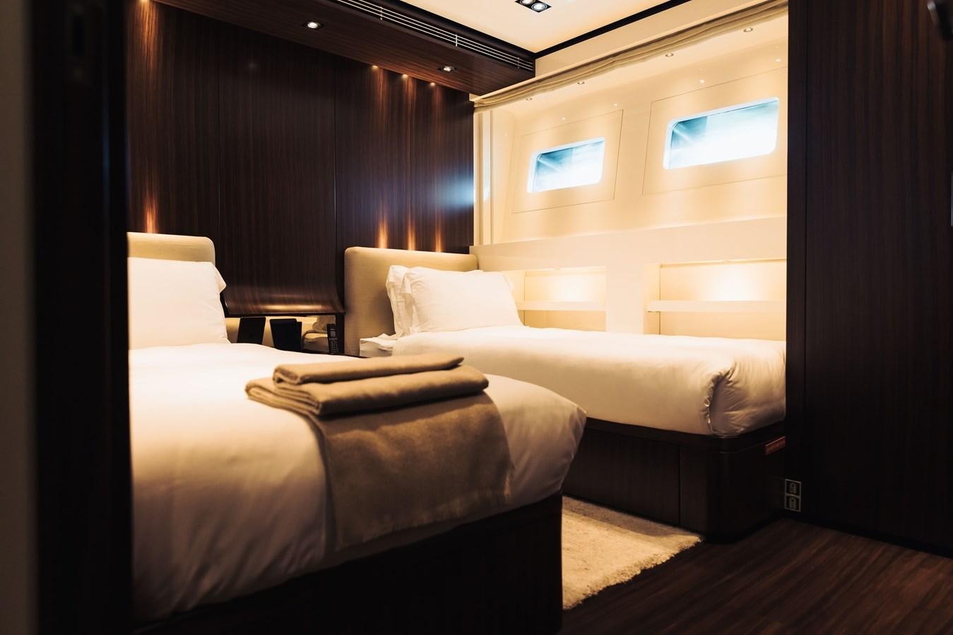 a room with beds and a tv aboard LUCKY ME Yacht for Sale