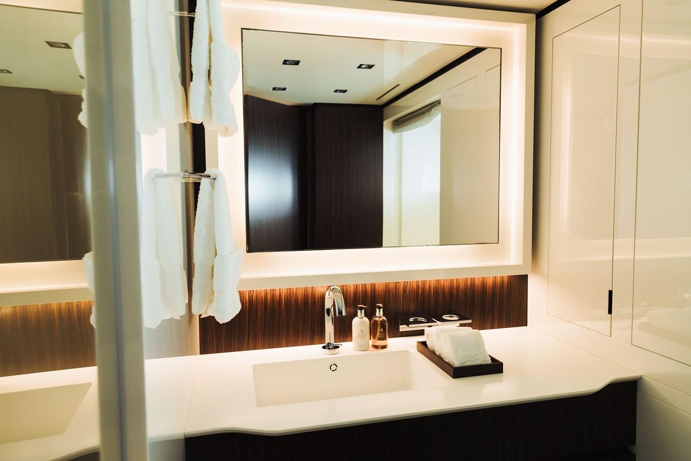 a bathroom with a large mirror aboard LUCKY ME Yacht for Sale