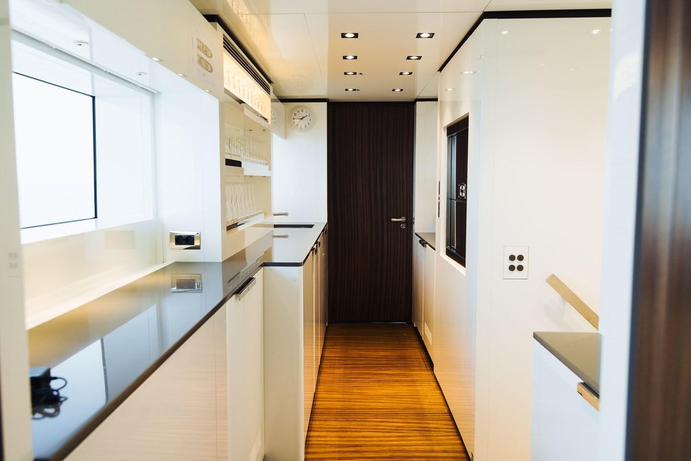 a hallway with white cabinets aboard LUCKY ME Yacht for Sale