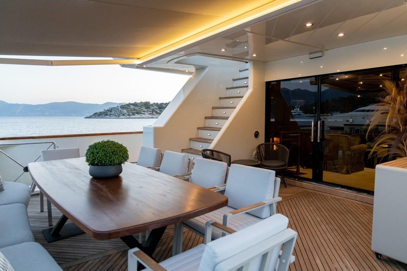 a room with a table chairs and a large window aboard AQUILLA Yacht for Sale