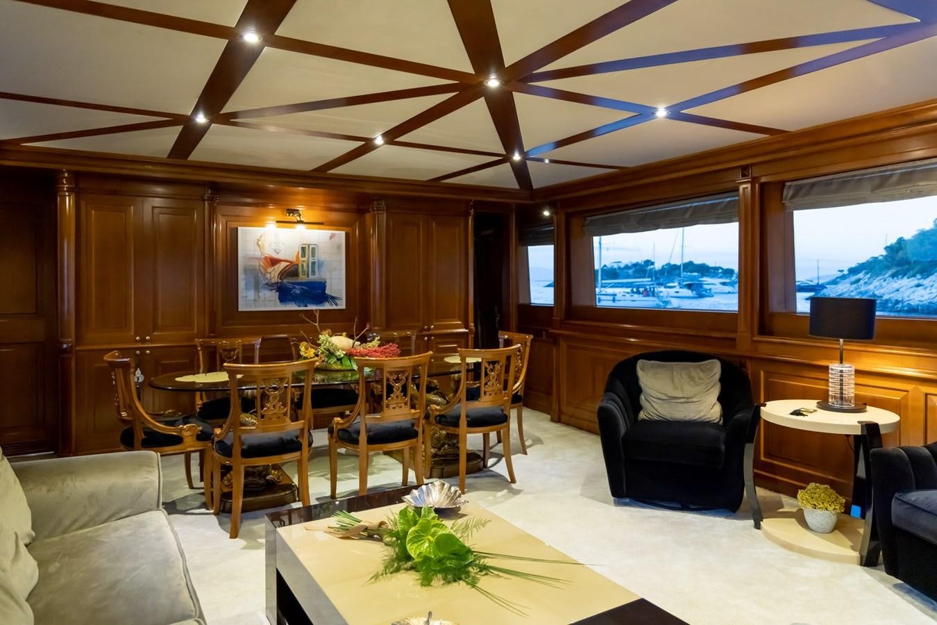 a living room with a table and chairs aboard AQUILLA Yacht for Sale