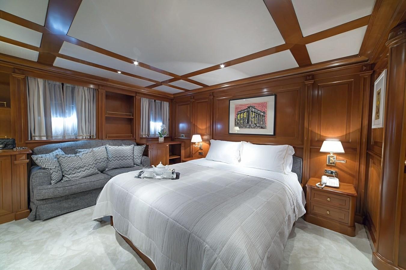 a bedroom with a bed and a couch aboard AQUILLA Yacht for Sale