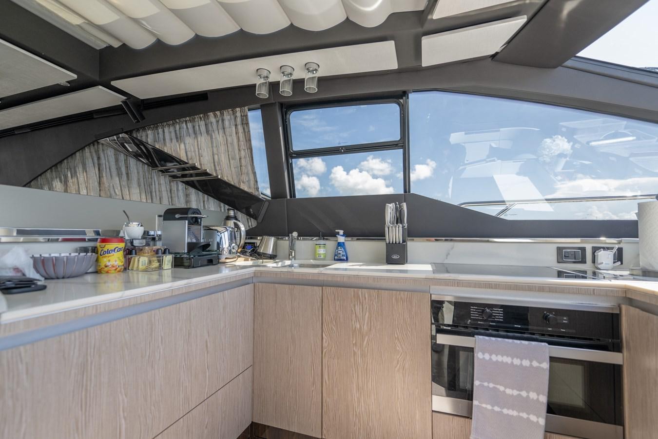a kitchen with a large window aboard CANDELARIA Yacht for Sale