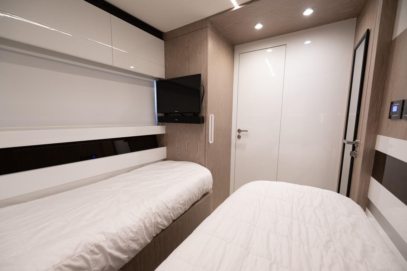 a room with a bed and a television aboard CANDELARIA Yacht for Sale