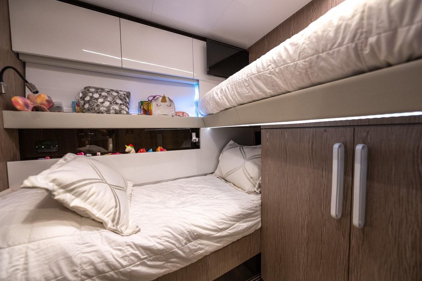 a bed with a white bed spread aboard CANDELARIA Yacht for Sale
