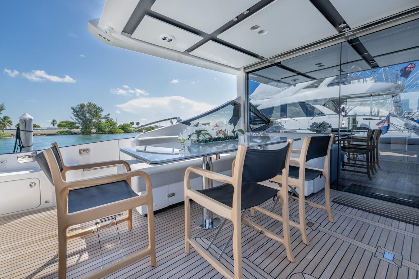 a deck with a table and chairs on it aboard CANDELARIA Yacht for Sale