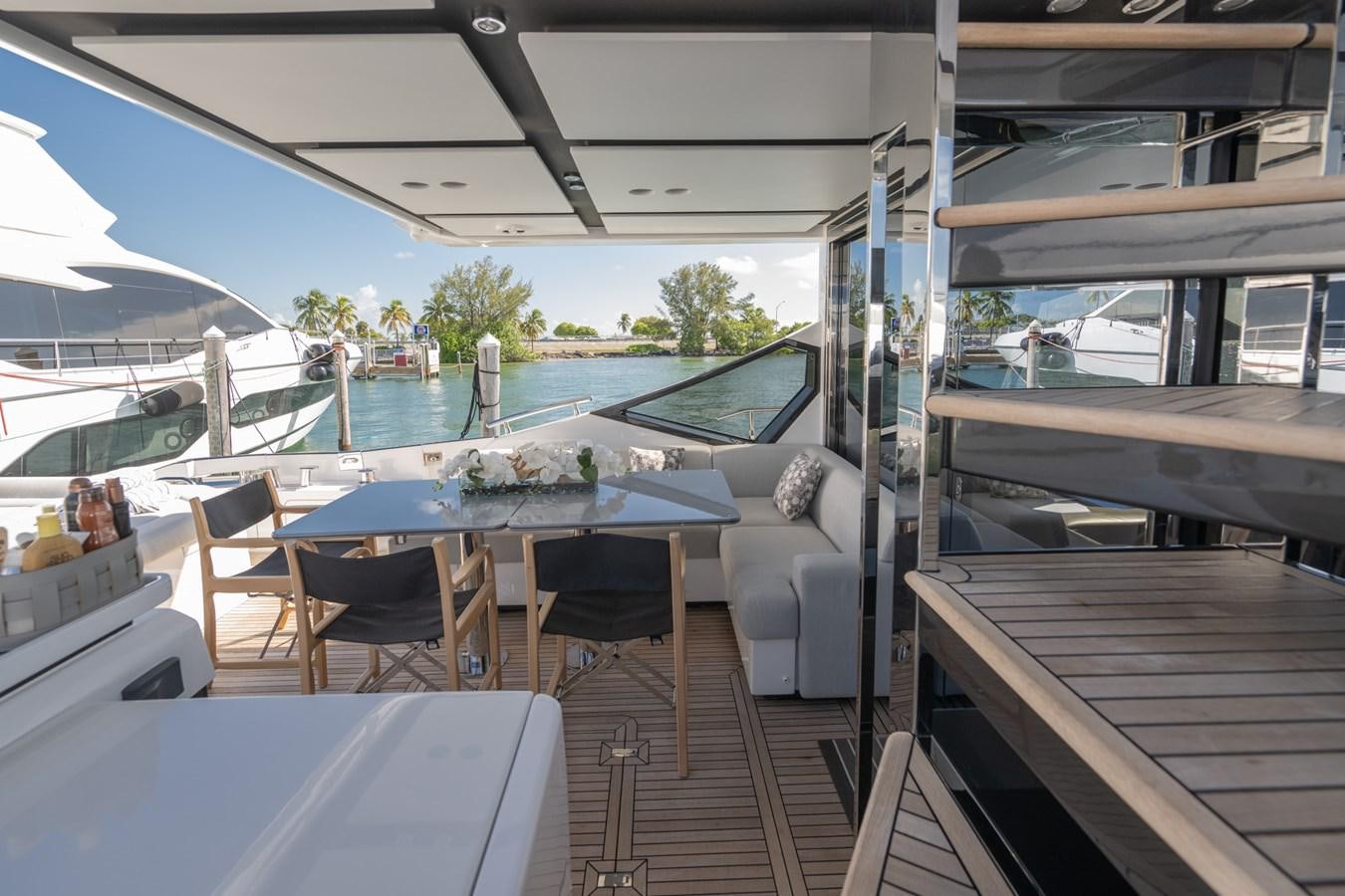 a deck with a table and chairs aboard CANDELARIA Yacht for Sale