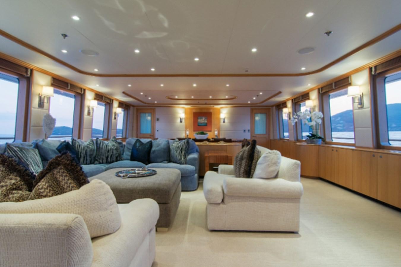 a living room with a couch and a table aboard 4*PUPPIES Yacht for Sale