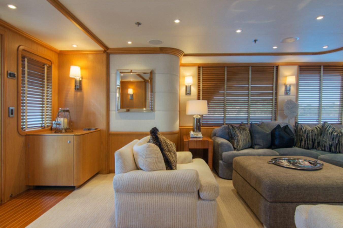 a living room with a couch and a mirror aboard 4*PUPPIES Yacht for Sale