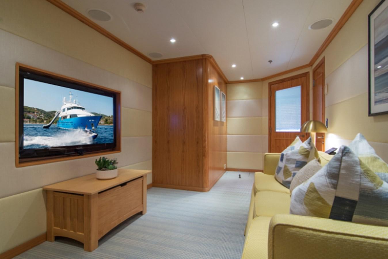 a living room with a large screen aboard 4*PUPPIES Yacht for Sale