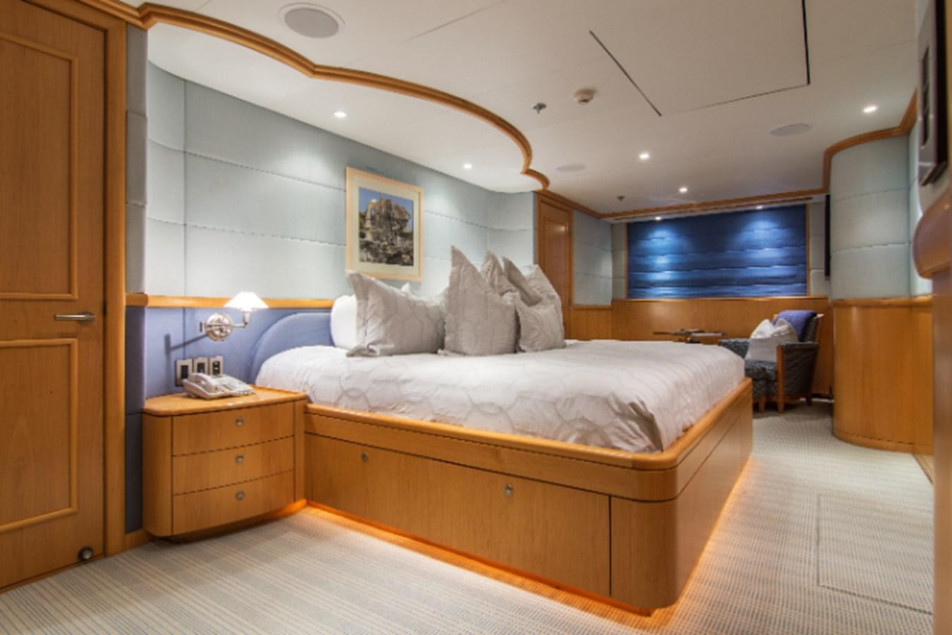a room with a bed and a dresser aboard 4*PUPPIES Yacht for Sale