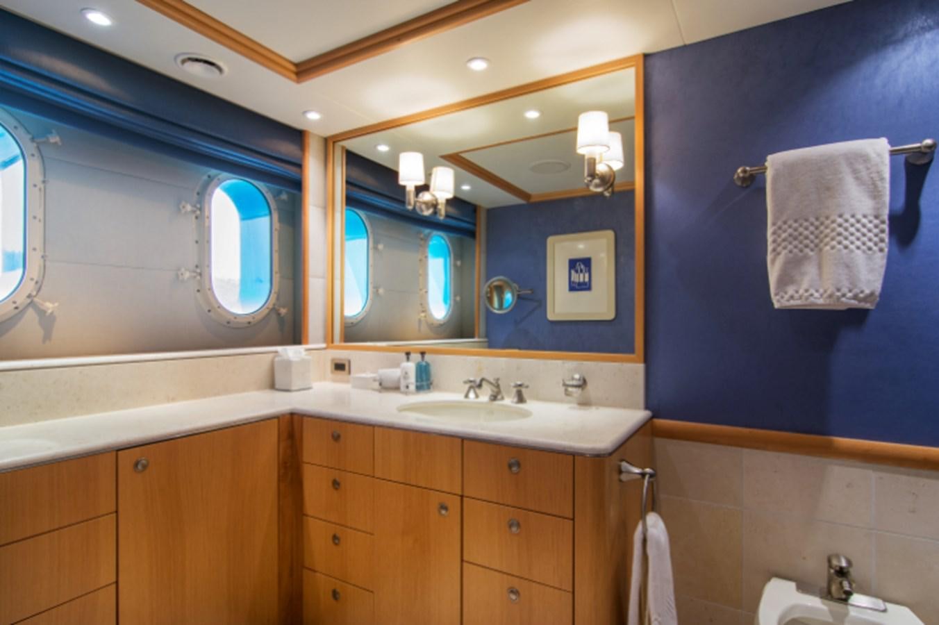 a bathroom with a sink and a mirror aboard 4*PUPPIES Yacht for Sale