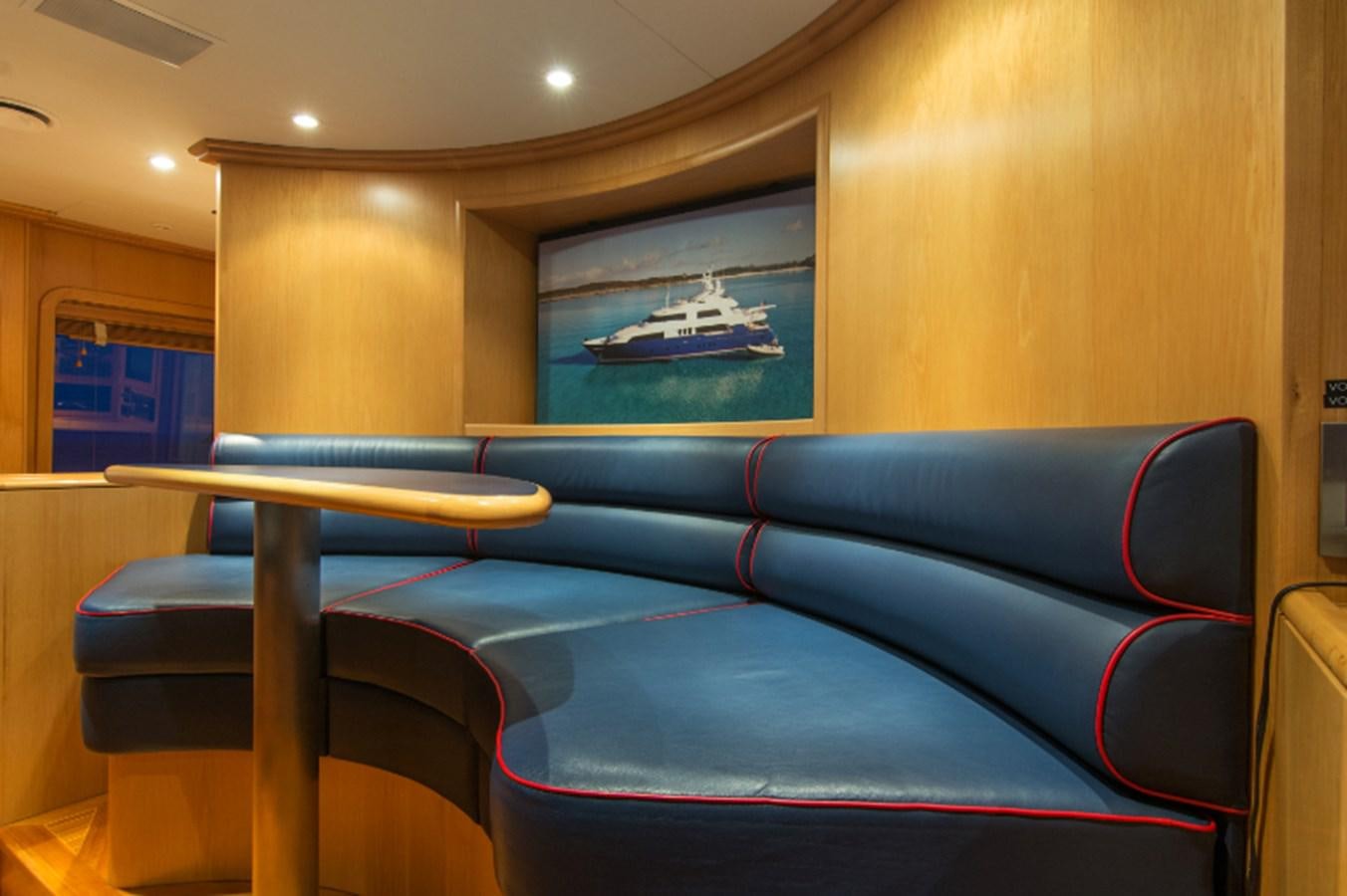 a blue couch in a room aboard 4*PUPPIES Yacht for Sale