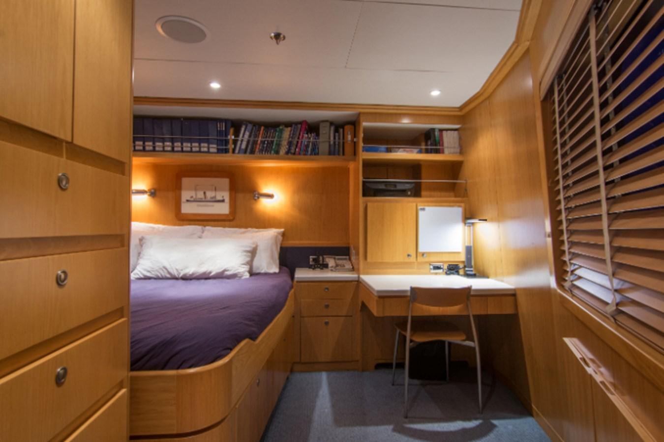 a room with a bed and a desk aboard 4*PUPPIES Yacht for Sale