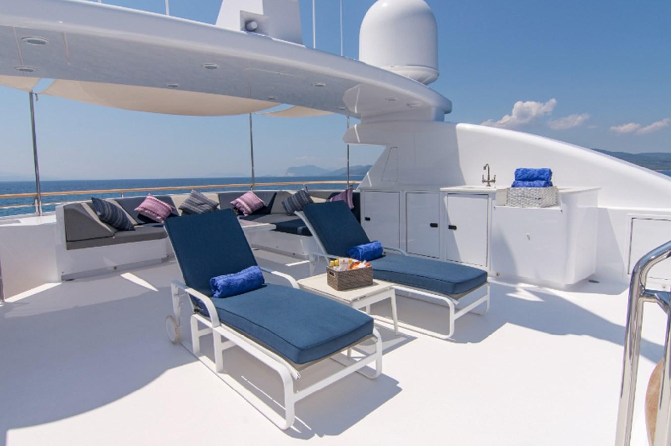 a room with a bed and a table on a boat aboard 4*PUPPIES Yacht for Sale