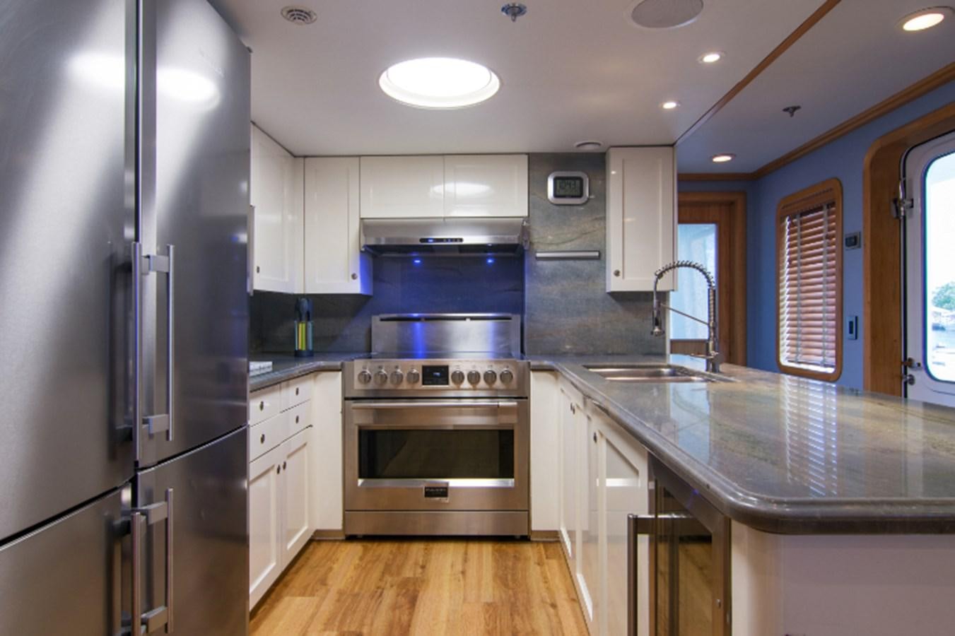 a kitchen with a stainless steel oven aboard 4*PUPPIES Yacht for Sale