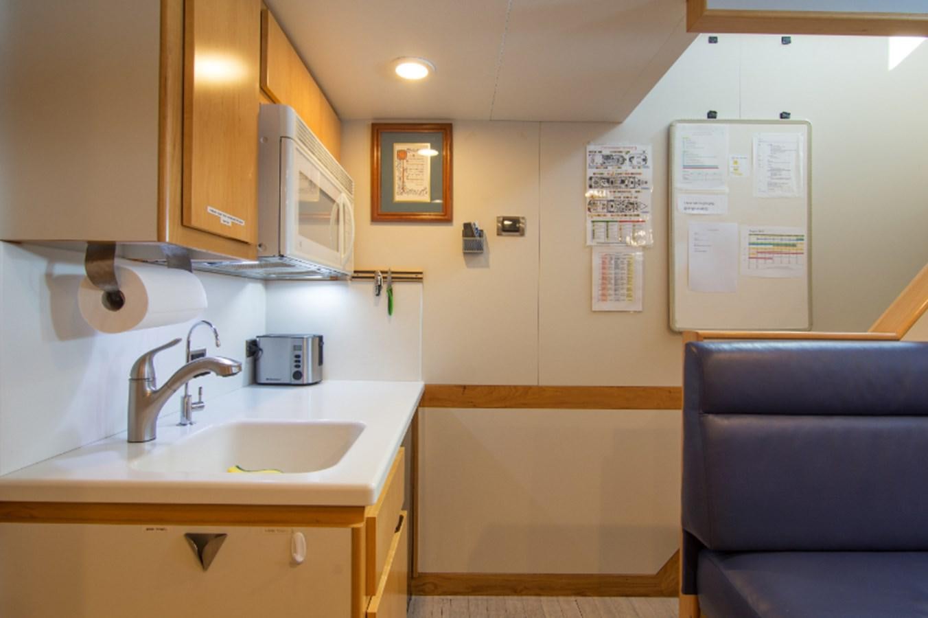 a kitchen with a sink and cabinets aboard 4*PUPPIES Yacht for Sale
