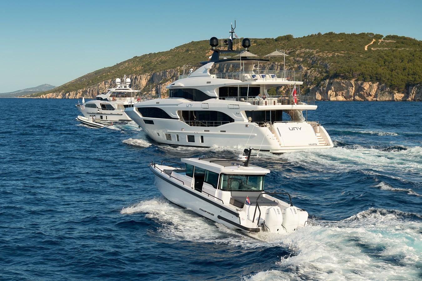 a group of boats on the water aboard UNY Yacht for Sale