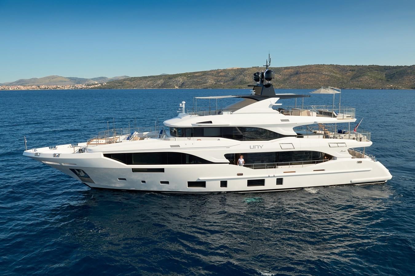 a white yacht in the water aboard UNY Yacht for Sale
