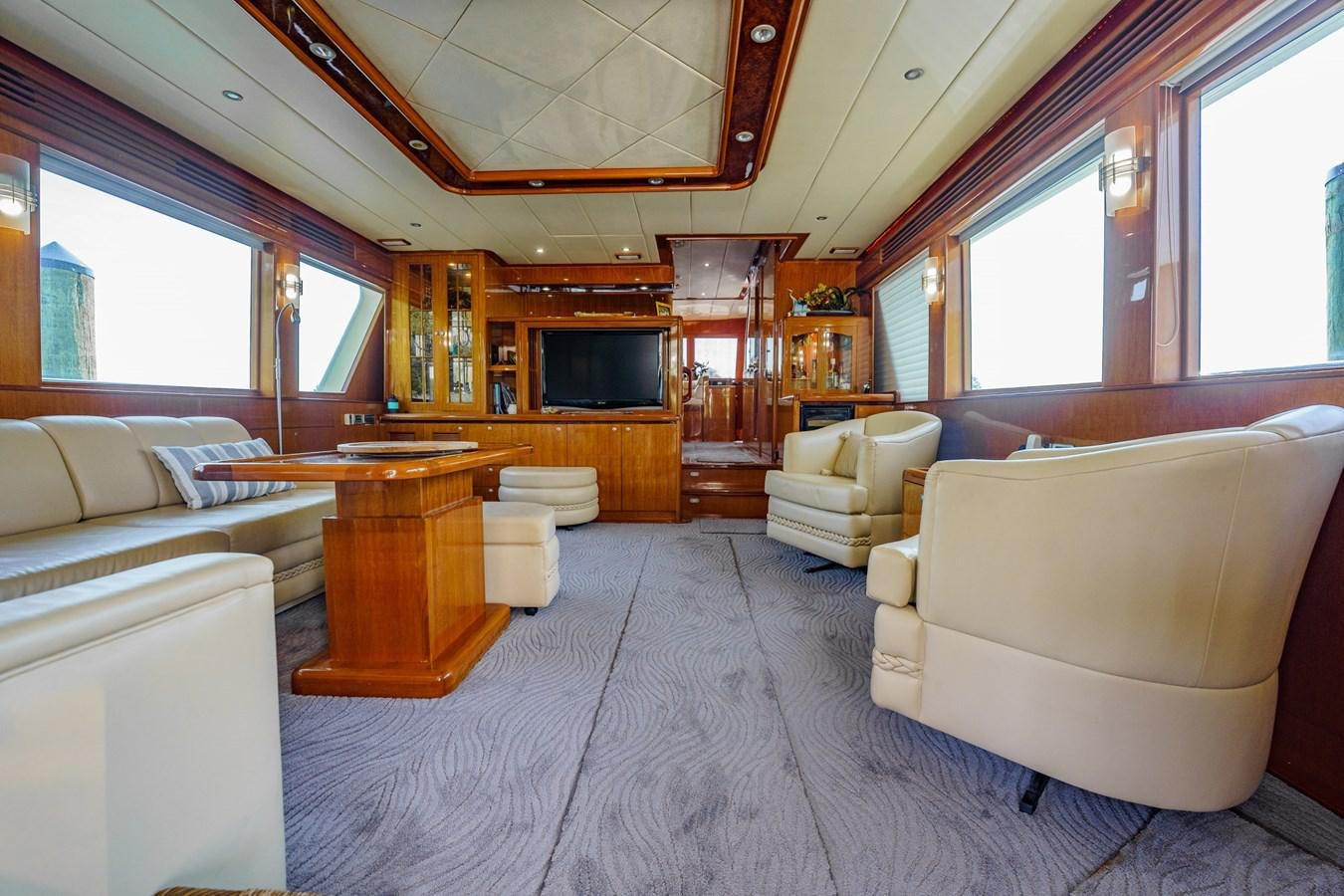 a room with a couch and a table aboard THREE OF A KIND Yacht for Sale