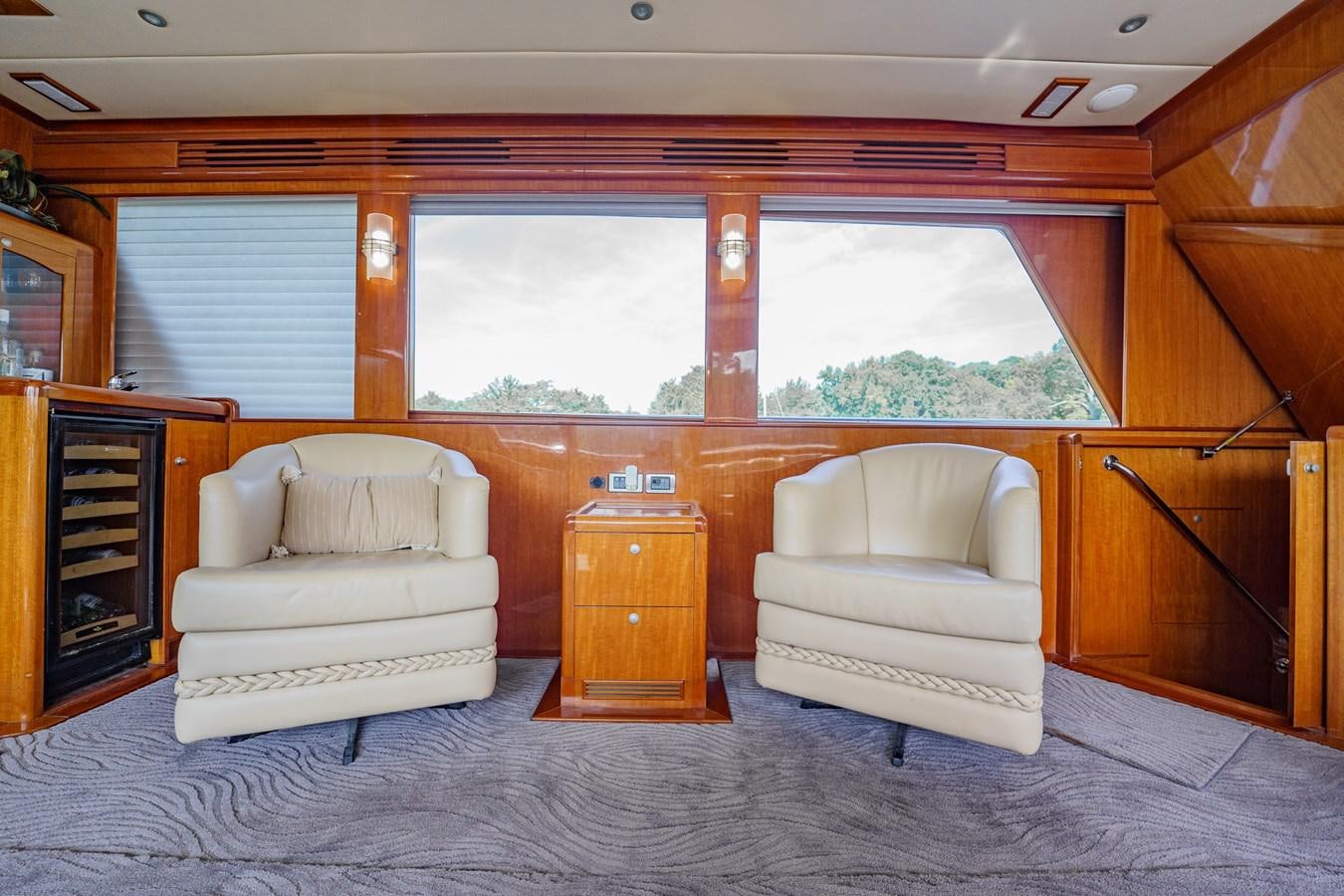 a living room with a couch and a fireplace aboard THREE OF A KIND Yacht for Sale