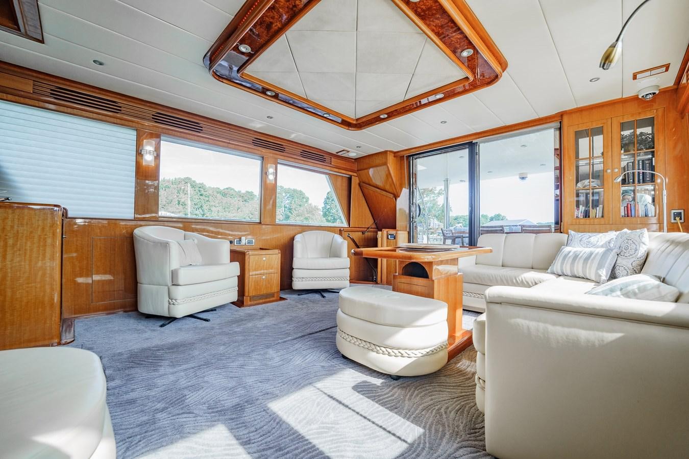 a living room with a large open window aboard THREE OF A KIND Yacht for Sale