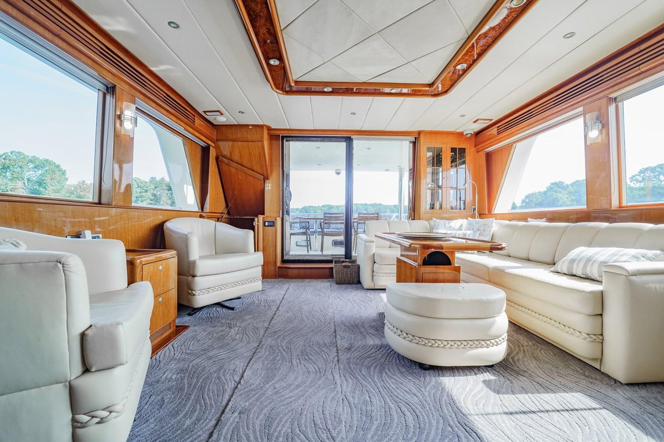 a large living room with a large window aboard THREE OF A KIND Yacht for Sale
