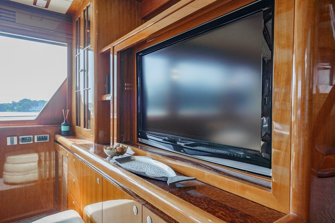 a tv on a wall aboard THREE OF A KIND Yacht for Sale