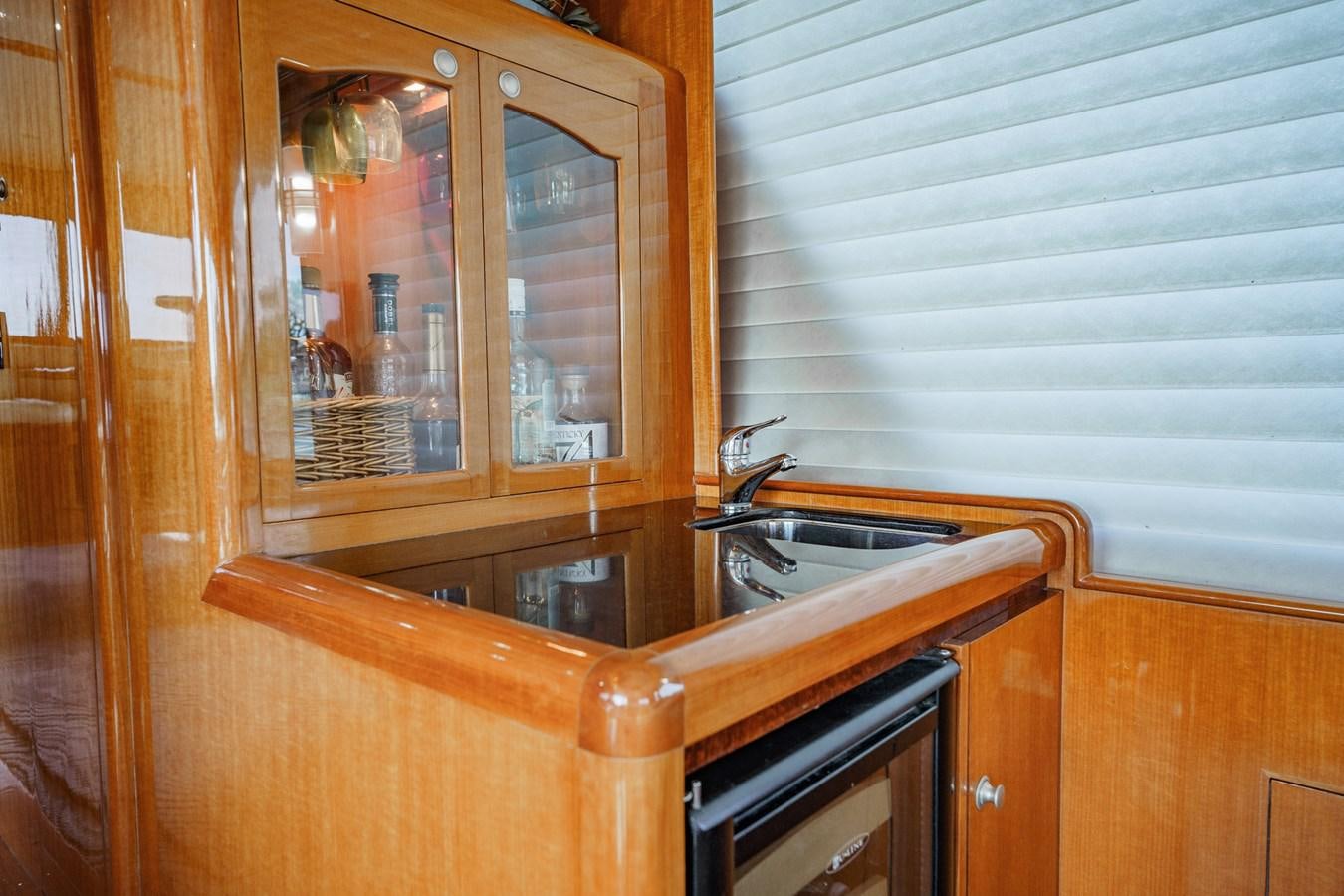 a kitchen with a sink and a mirror aboard THREE OF A KIND Yacht for Sale