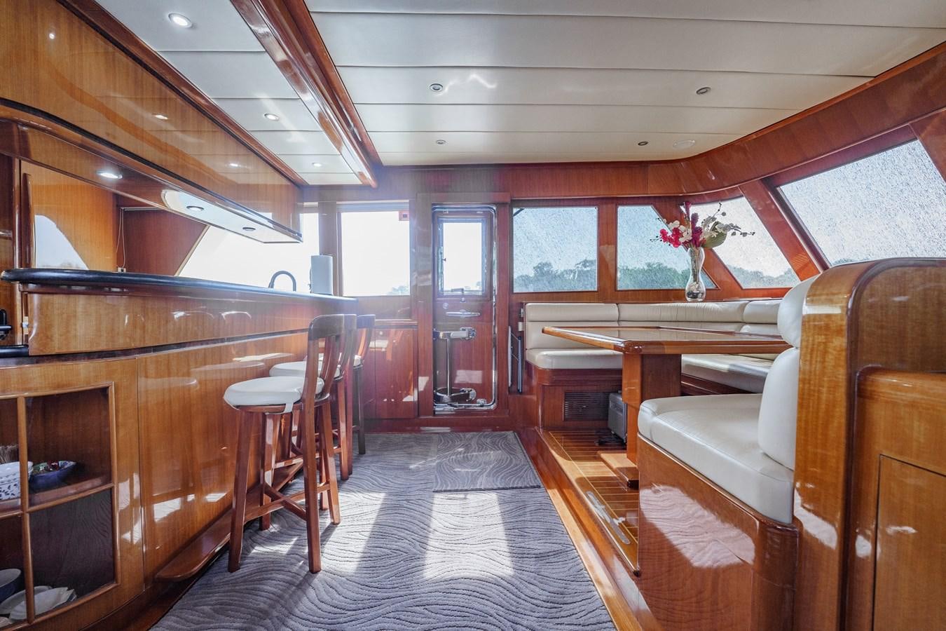 a room with wooden furniture aboard THREE OF A KIND Yacht for Sale
