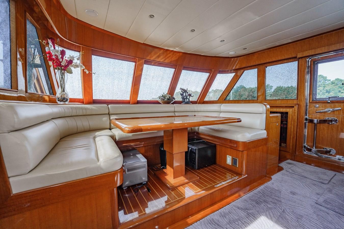 a room with a couch and a table aboard THREE OF A KIND Yacht for Sale
