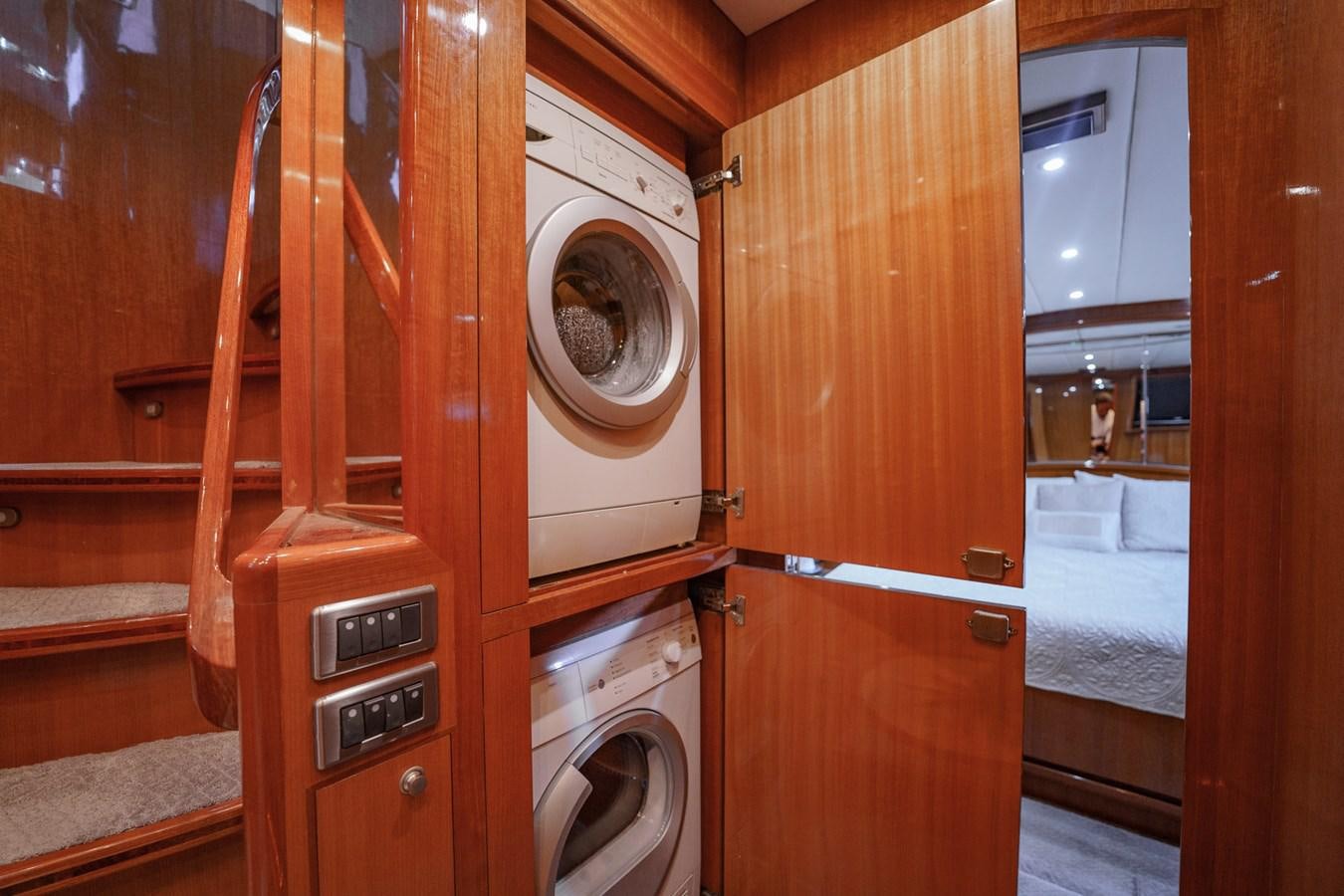 a room with a washing machine and dryer aboard THREE OF A KIND Yacht for Sale