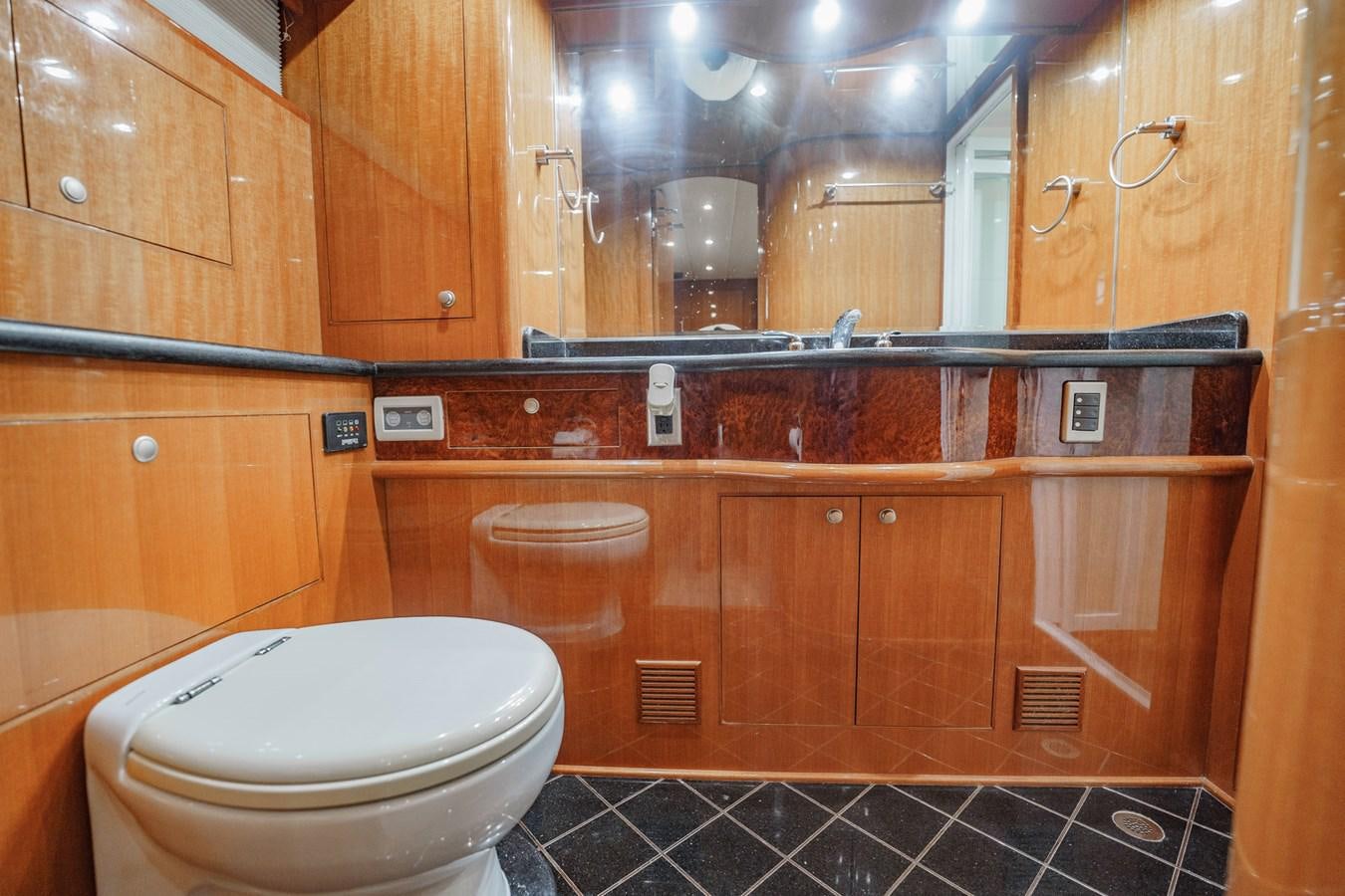 a bathroom with wooden cabinets aboard THREE OF A KIND Yacht for Sale