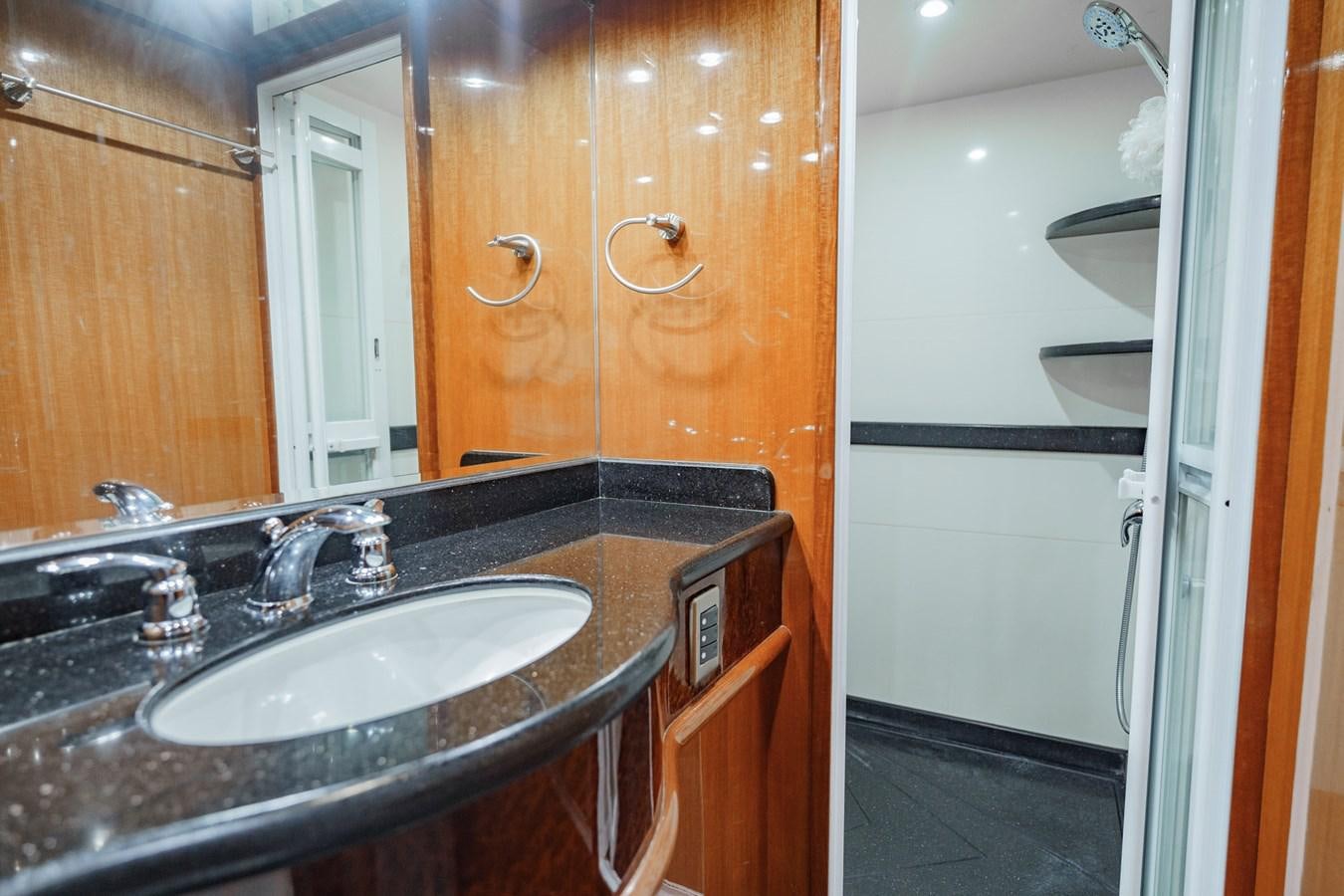 a bathroom with a sink and a mirror aboard THREE OF A KIND Yacht for Sale