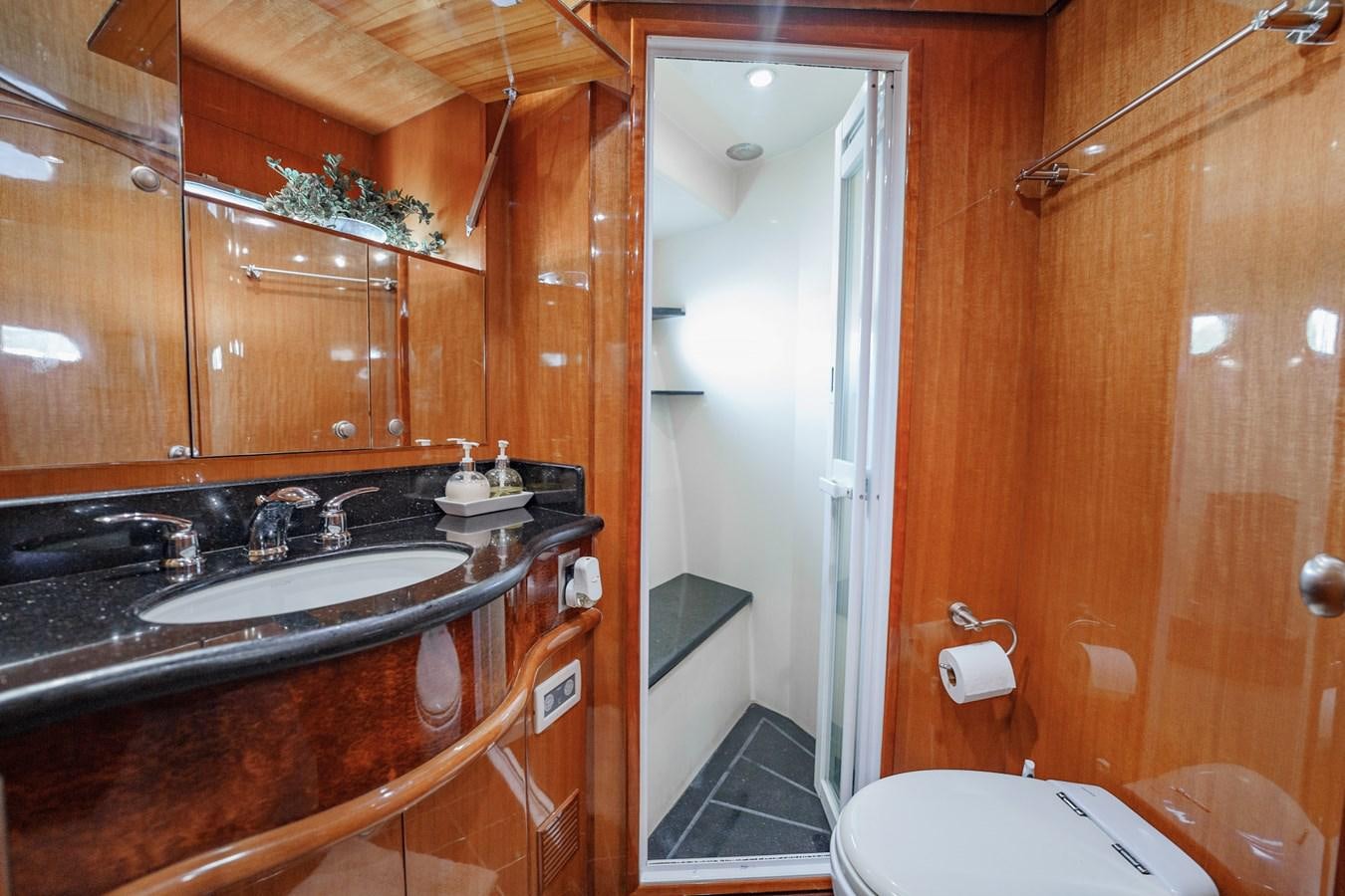a bathroom with wooden cabinets aboard THREE OF A KIND Yacht for Sale