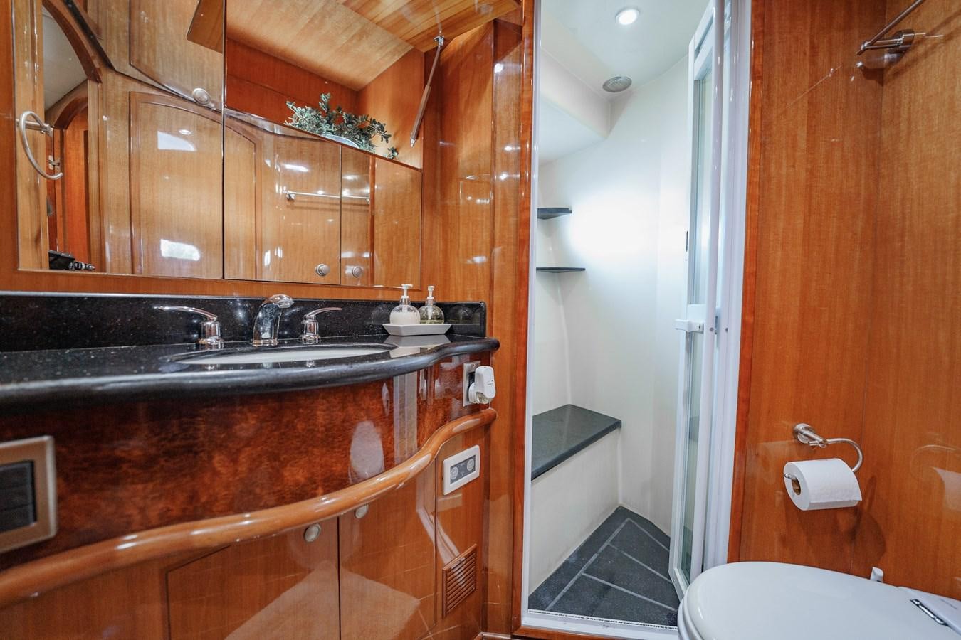 a bathroom with wooden cabinets aboard THREE OF A KIND Yacht for Sale