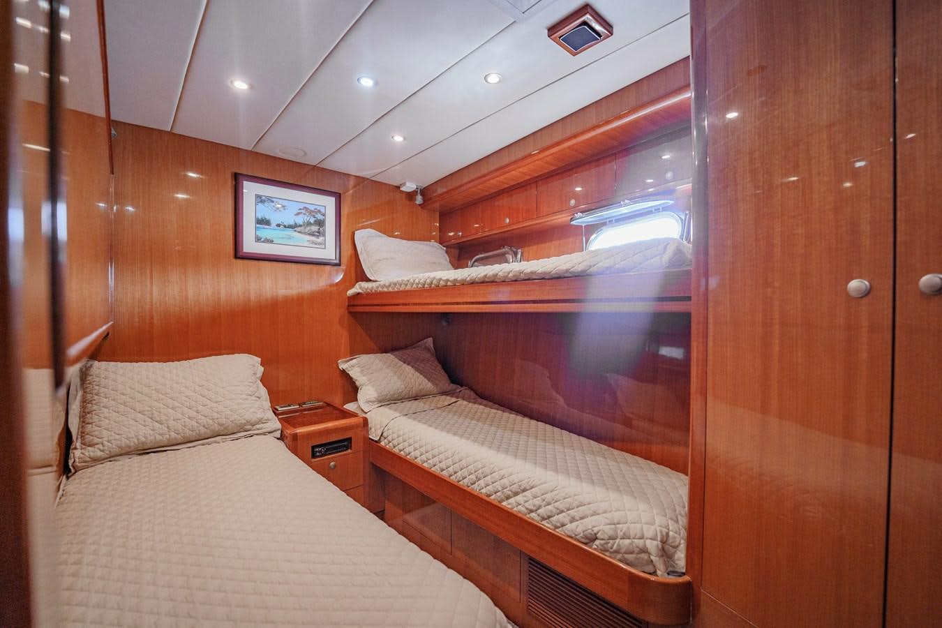 a room with two beds aboard THREE OF A KIND Yacht for Sale