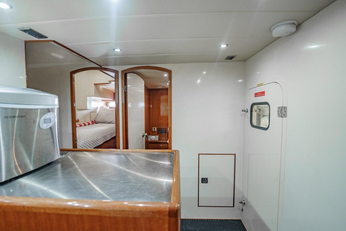 a room with a bed and a sink aboard THREE OF A KIND Yacht for Sale