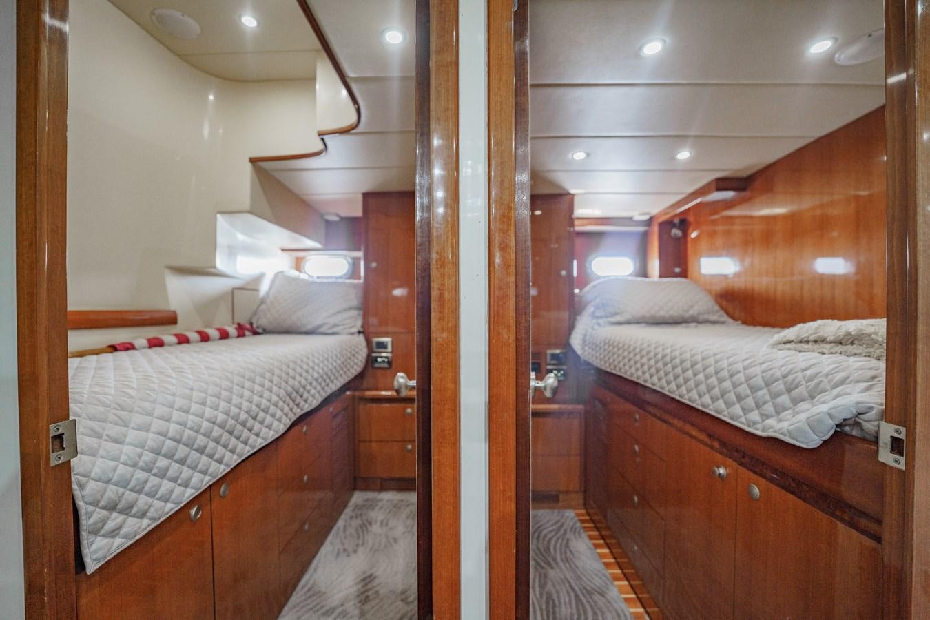 a room with a couple beds aboard THREE OF A KIND Yacht for Sale